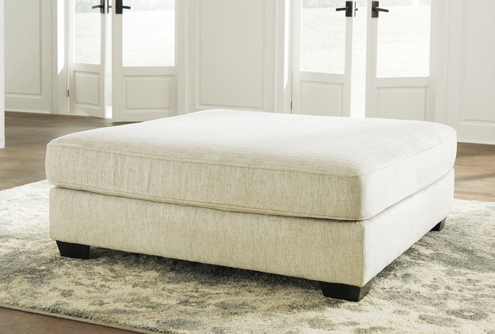 Make room for big-time comfort and style with this oversized ottoman. Designed to multitask as a footrest and casually cool coffee table, this firmly cushioned square ottoman is covered in a decadently soft chenille microfiber thatâ€™s love at first touch