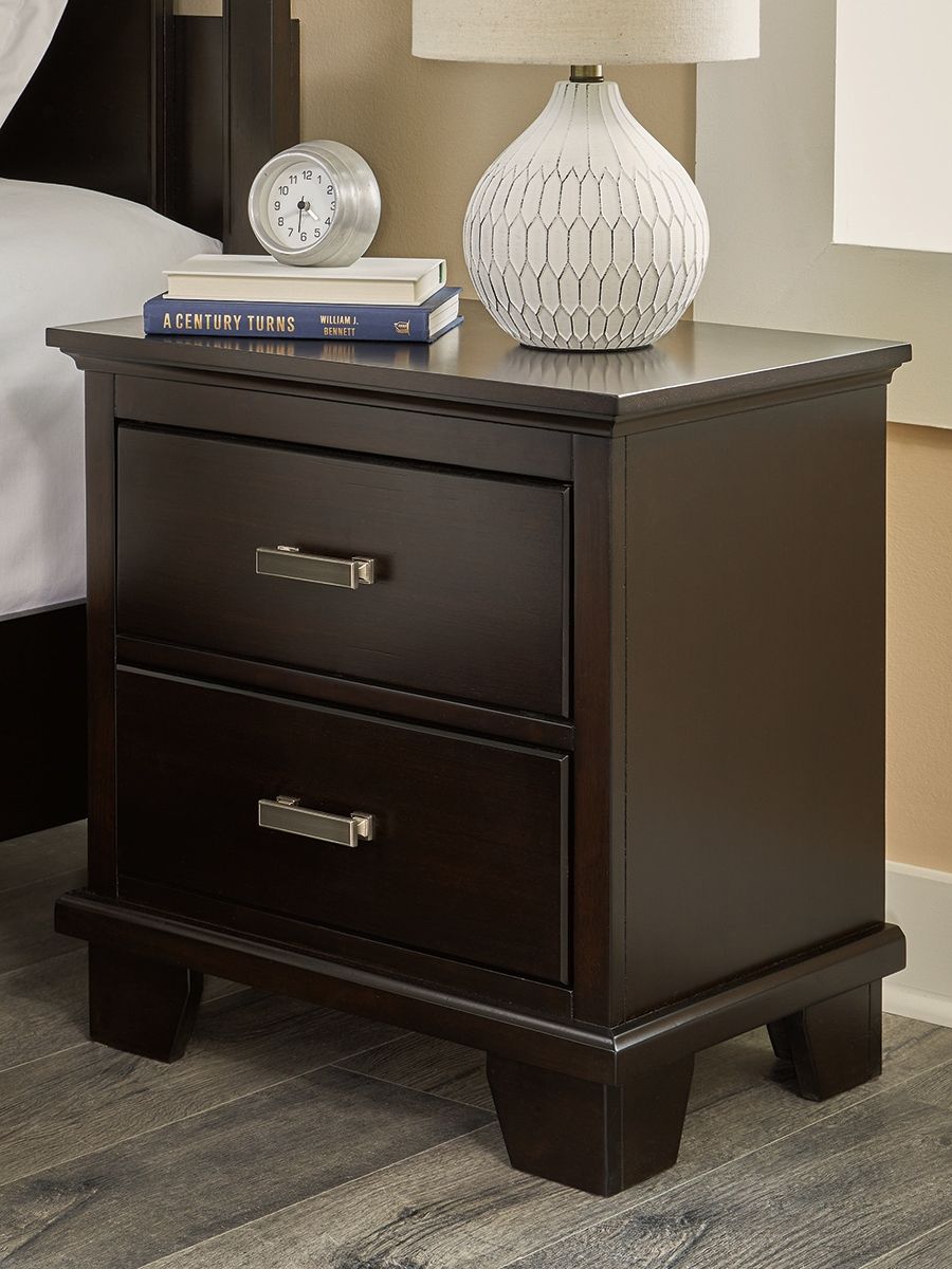 Feast your eyes on this richly versatile nightstand. Its traditional-inspired dark brown finish effortlessly blends with contemporary bright nickel-tone pulls to create a stunning look that-'s not too stuffy or too trendy. Spacious drawers offer plenty of