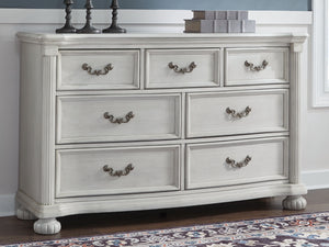  highlighted by a serpentine-shaped front with thick decorative moulding. Its drawers are pac