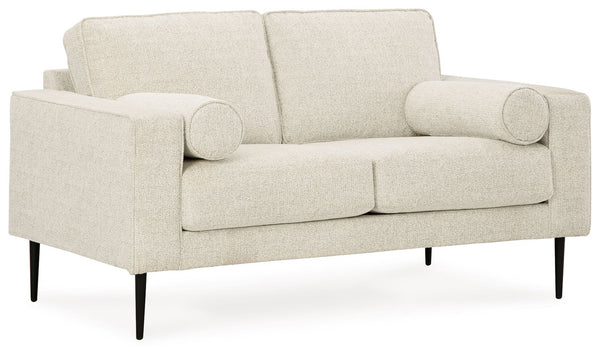 Simple comfort meets modern function in this loveseat. An apt addition to apartments and other small spaces, this slim-profiled piece welcomes you with its cozy character. A subtle chevron pattern on the cushions refreshes the classic neutral hue, elevati