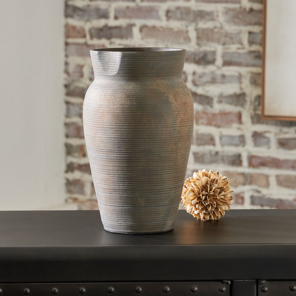 Contain your enthusiasm for casual earthy elegance. Loaded with a sense of antiqued beauty, this stunning ceramic vase adds a beautiful timeworn quality to your home. Let it wow on its own, or kick things up a notch and fill it with faux or dried bouquets