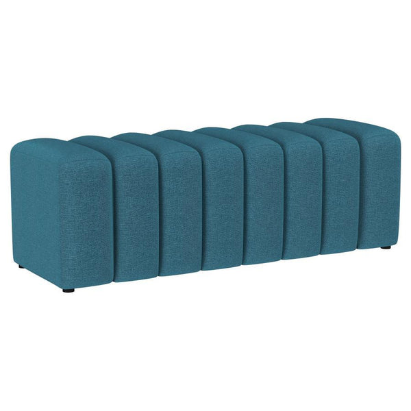 Introduce glam texture and dimension with a decorative upholstered bench. This modern creation features an undulating silhouette without arms or a back, offering sleek style and seating. Perfect for a sophisticated foyer or living room, it adds a pop of c