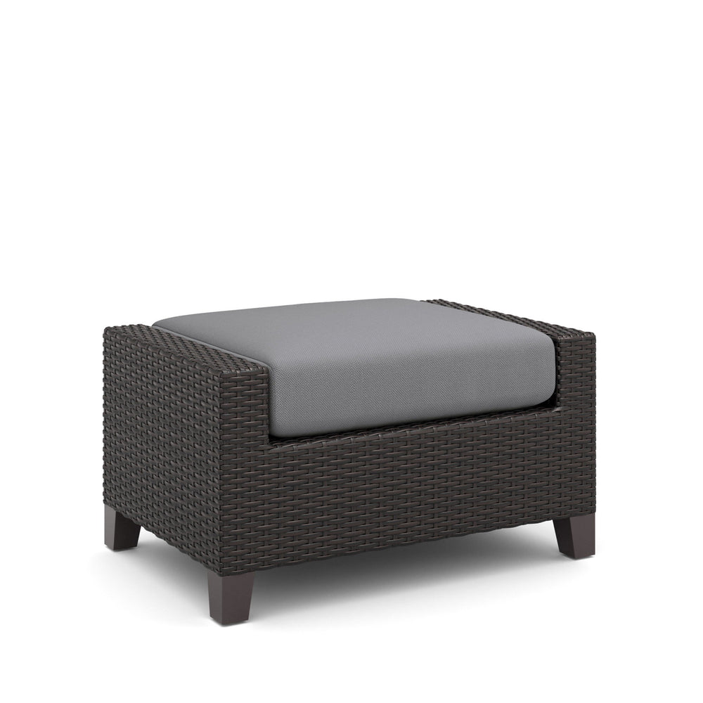 The Skye Outdoor Ottoman Set in Gray includes 2 cushioned ottomans and is crafted with durable aluminum frames and a baked-on powder finish to ensure longevity and scratch resistance. The high-density HDPE wicker mimics the look of natural wicker while be