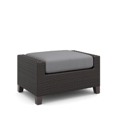 The Skye Outdoor Ottoman Set in Gray includes 2 cushioned ottomans and is crafted with durable aluminum frames and a baked-on powder finish to ensure longevity and scratch resistance. The high-density HDPE wicker mimics the look of natural wicker while be