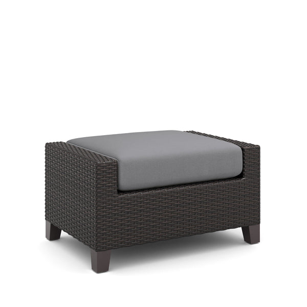 The Skye Outdoor Ottoman Set in Gray includes 2 cushioned ottomans and is crafted with durable aluminum frames and a baked-on powder finish to ensure longevity and scratch resistance. The high-density HDPE wicker mimics the look of natural wicker while be