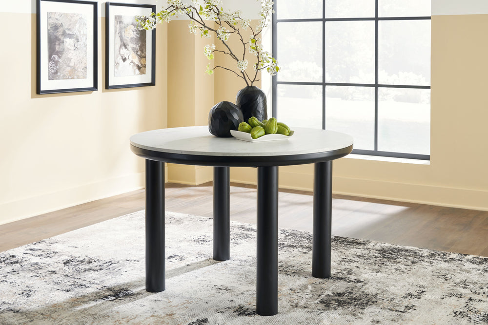 Clean lines meet cool curves with this dining table. Chunky round post legs and a black finish lend a modern vibe, while a replicated white marble top completes the casual lifestyle design. What a delicious choice for a dining room update.<br><br><b>Addit