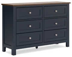 Add homespun charm to your restful retreat. A modern take on a timeless silhouette, this dresser pairs a dark slate blue finish with a light brown top. Drawer fronts and legs in a classic Shaker style bring an air of beautiful simplicity to the bedroom. W