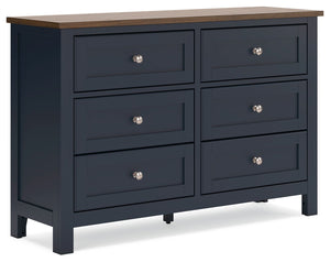 Add homespun charm to your restful retreat. A modern take on a timeless silhouette, this dresser pairs a dark slate blue finish with a light brown top. Drawer fronts and legs in a classic Shaker style bring an air of beautiful simplicity to the bedroom. W
