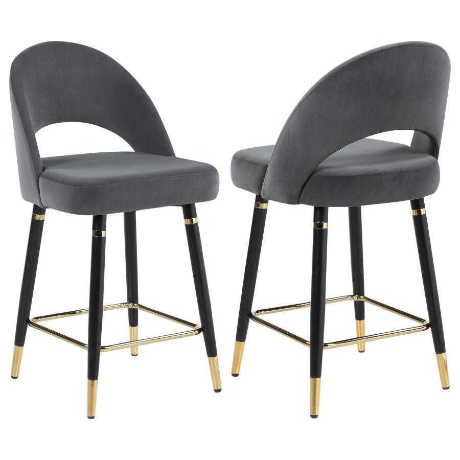 This set of two counter height stools features an elegant bucket style seat that lends a retro-inspired Mid Century modern look. Each stool offers long-lasting, supportive seats for each guest, wrapped in faux leather upholstery that complements numerous 