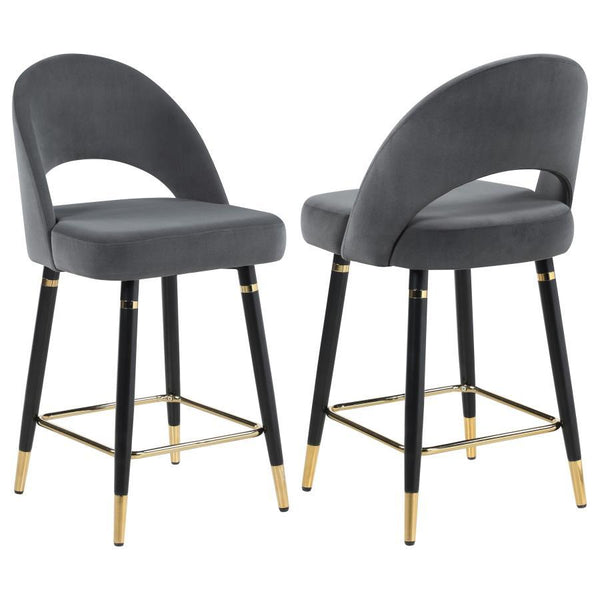 This set of two counter height stools features an elegant bucket style seat that lends a retro-inspired Mid Century modern look. Each stool offers long-lasting, supportive seats for each guest, wrapped in faux leather upholstery that complements numerous 