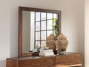  sturdy mirror is crafted for quality. Its frame boasts a pleasing finish of smokey walnut. Its large size makes it ideal for a master bedroom. Affix this mirror to a matching dresse