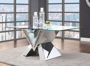 Cultivate a contemporary aesthetic in your entertainment ensemble with this distinctive Noralie dining table. Offering a modern twist on a classic pedestal-style silhouette, this design showcases an angular base with mirror and faux diamond inlay and uniq