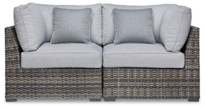 This cool, casual outdoor chair will raise the comfort level and visual appeal of your outdoor living space. Made of handwoven wicker in neutral tones of light and dark gray, the cushioned corner chair blends beautifully into your lanai or pool and patio 