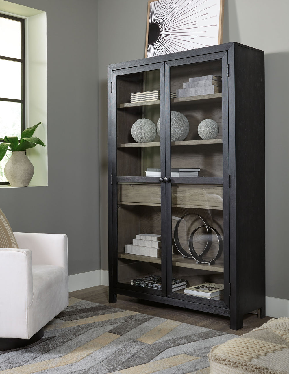 Add layers of form and function to your space with this accent cabinet. It-'s draped in a black finish on the outside and a warm gray finish inside, for a classic look that seamlessly transitions from casual to modern styles. The accent cabinet-'s flexibl