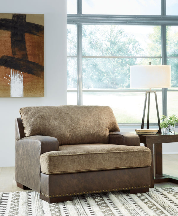  this chair is perfect for those who love the look of leather. Two textural tones provide twice the style and comfortâ€”and incorporate an added layer of visual interest. The piece is punctuated by a subtle band of nailhead 