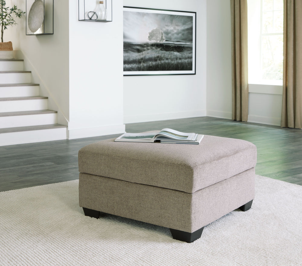 This ottoman adds a richly neutral aspect to your living space. This versatile companion piece offers ample storage space plus a tabletop with cup holders on the reverse side of the removable cushion.<br><br><b>Additional Dimensions</b><br><ul><li>Leg hei