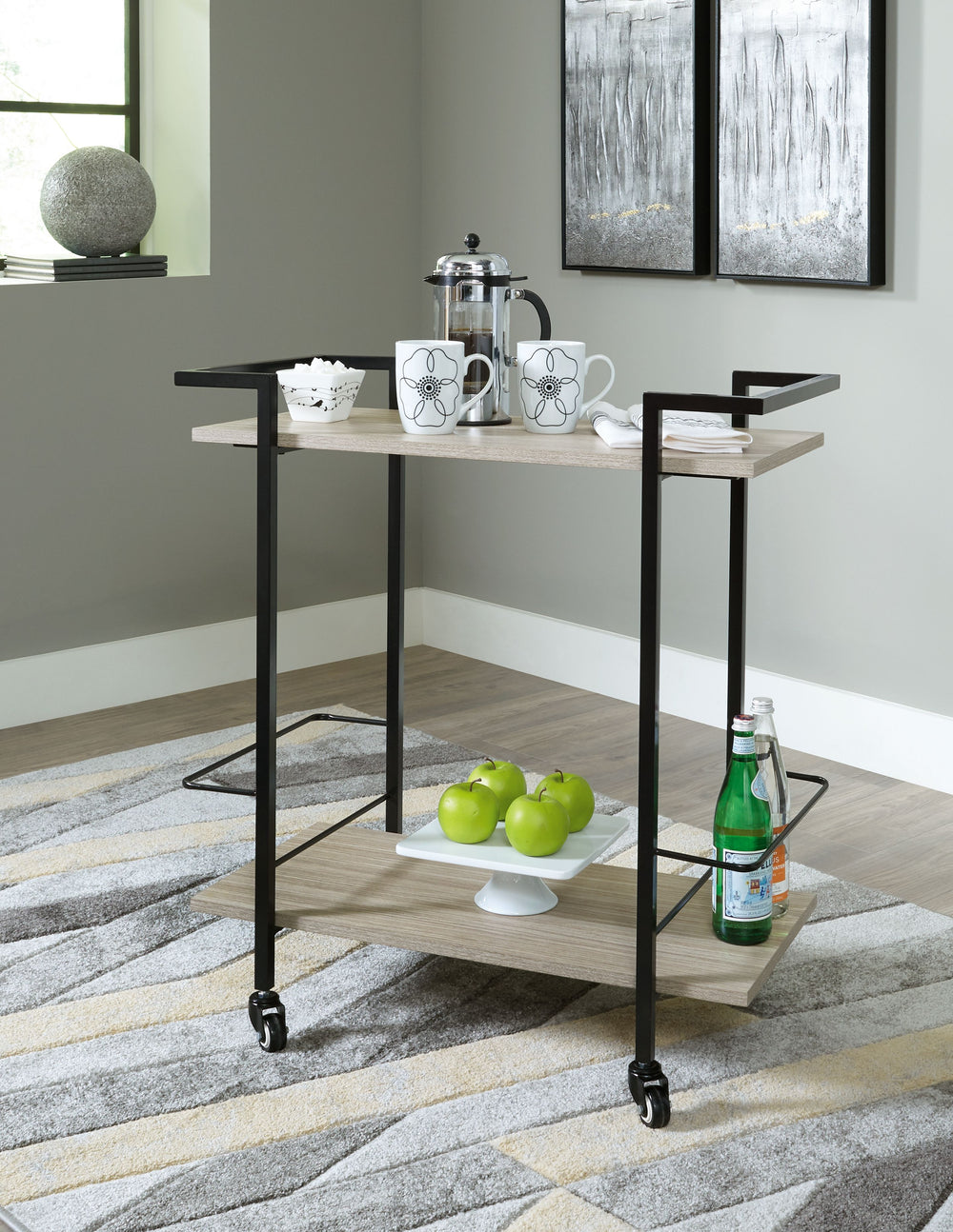 Contemporary meets casual to create the ultimate spot to serve and display. Crafted of durable MEGA-TUFFÂ® melamine with a light natural wood grain effect, this bar cart sets a new standard for substance and streamlined design. Black bottle holders keep s