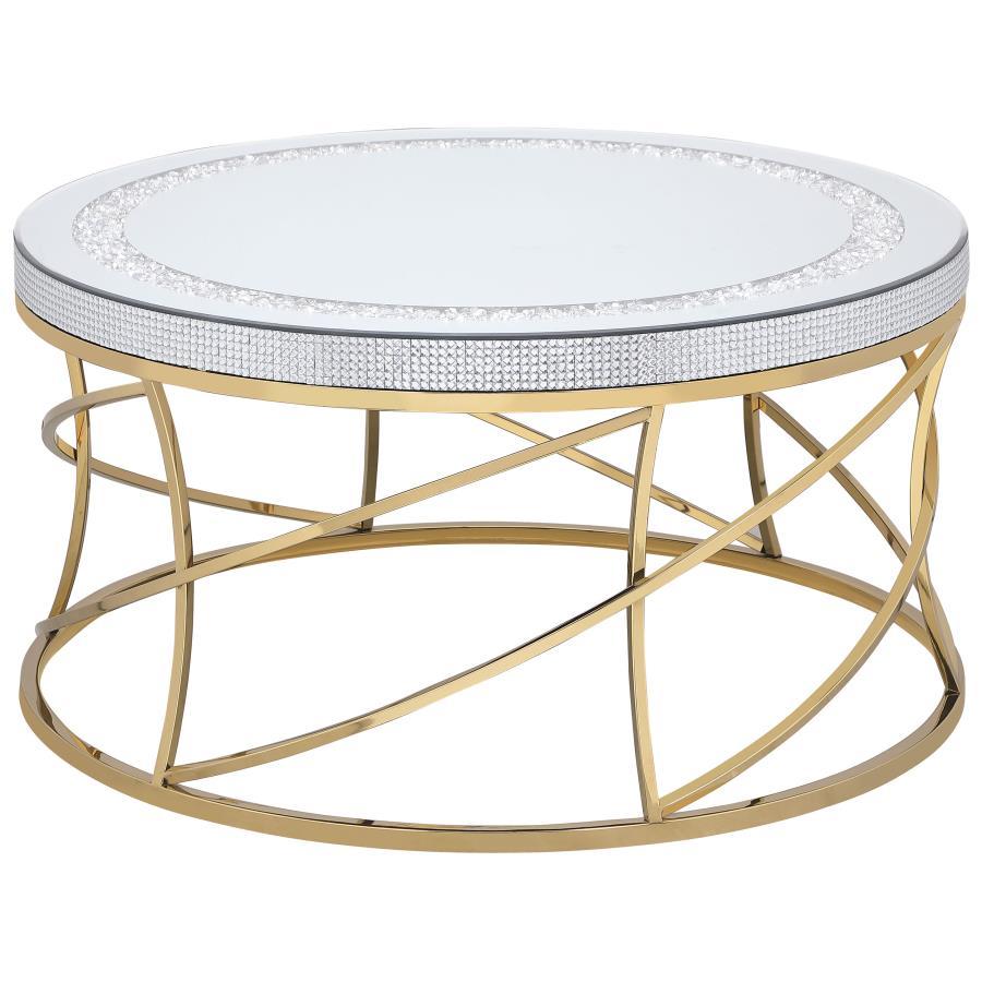 Golden spirals and spindles create a fresh sense of movement and energy in this round coffee table. The mirrored top is framed by an inset ring of acrylic crystals, creating a jewel-like effect that adds texture and depth. Acrylic crystals adorn the edge 