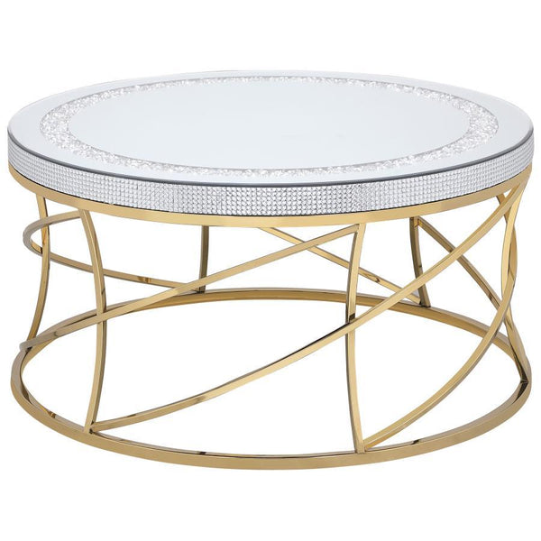 Golden spirals and spindles create a fresh sense of movement and energy in this round coffee table. The mirrored top is framed by an inset ring of acrylic crystals, creating a jewel-like effect that adds texture and depth. Acrylic crystals adorn the edge 