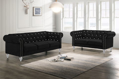 The New Classic Emma Chesterfield Velvet 2-Piece Sofa and Loveseat Set offers a soft and elegant seating solution for your living space. The 100% polyester velvet fabric provides cozy and indulgent seating, while the tufted backs and arms, adorned with gl