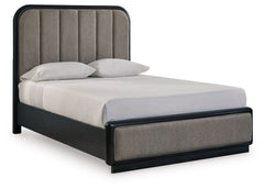 Inspired by art deco design, this softly shaped queen upholstered panel bed makes a lasting impression in a simply stunning way. Its magnificent curved silhouette is enhanced by a rich layered black finish on the textured wood grain surface. The channeled