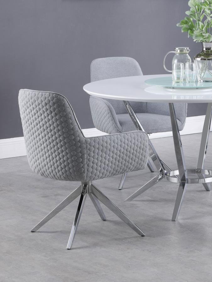 Blending mid-century modern design with contemporary comfort, this swivel dining armchair offers both style and function. Upholstered in light grey fabric, it features a plush bucket seat with low arms and a tall backrest for exceptional support. The hone
