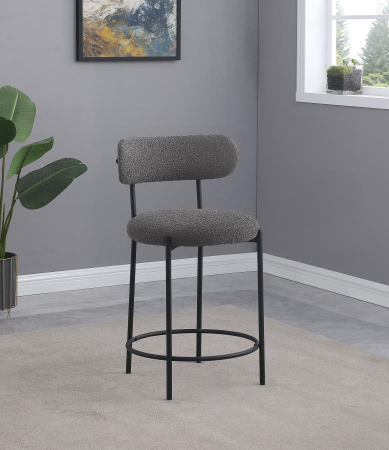 Your kitchen island or counter table gets an instant upgrade with this set of two modern barstools. The pair features contemporary boucle upholstery in a neutral hue over foam cushions for comfort. Metal framing features a black finish and provides excell