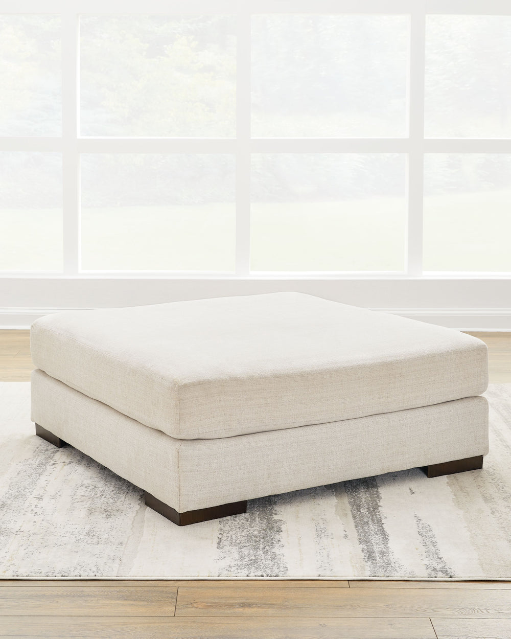 Relax in style on this oversized ottoman. With a look and feel inspired by fine menswear, the spacious piece has rich textures that are easy on the eyes and a pleasure to touch. Its soft, neutral hue and smart tailoring look right at home in any decor.<br