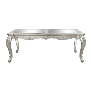  the Devayne dining table brings in all the allure and charm that you are seeking for a dining table. The table features an extension leaf that allows for additional dinner guests. The champagne finish enhances the beautiful 