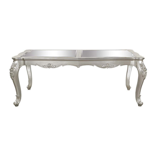  the Devayne dining table brings in all the allure and charm that you are seeking for a dining table. The table features an extension leaf that allows for additional dinner guests. The champagne finish enhances the beautiful 
