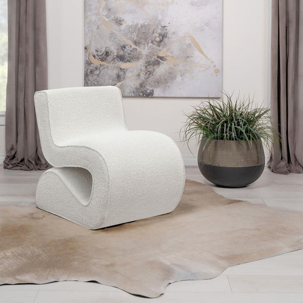  its bouclÃ© fabric not just on-trend but a textural revelation. The chair-'s unique shape is a conversation starter