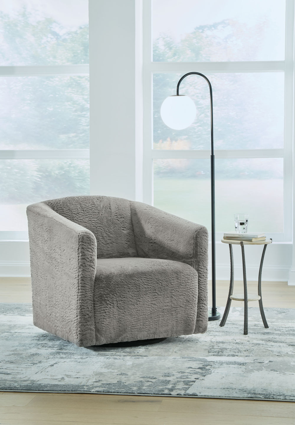 Craft a chic and cozy seating space with this accent chair. The swivel base makes it simple to hop from one conversation to another when hosting. Faux rabbit fur upholstery has a luxe look with a universal appeal. Whether you-'re serving up charcuterie to