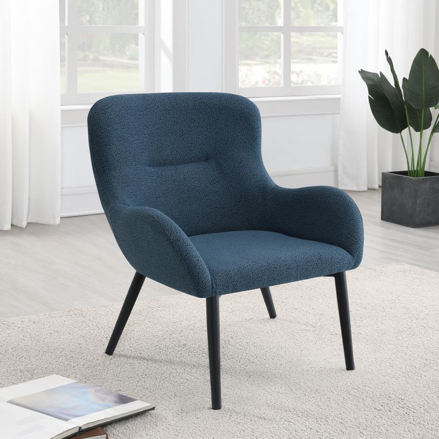 Add a touch of color to your living room seating ensemble with a modern accent armchair. Its inviting silhouette boasts prominent curves, with a rounded back and flared arms. A single line of tufting adds dimensionality to the look, while plush foam cushi