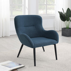  with a rounded back and flared arms. A single line of tufting adds dimensionality to the look