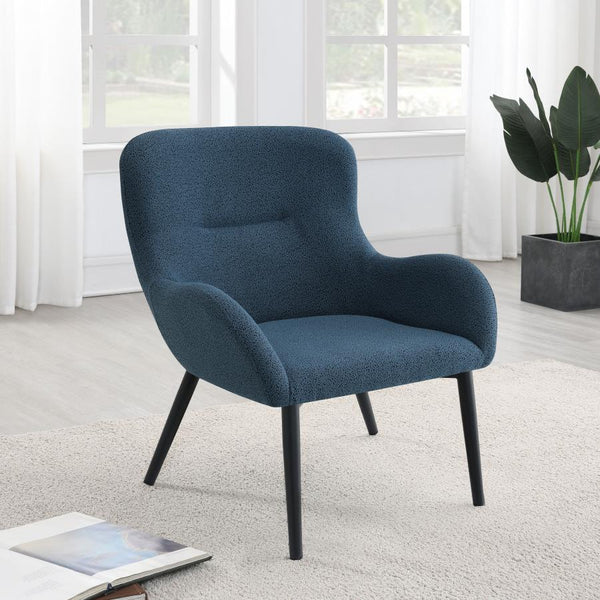  with a rounded back and flared arms. A single line of tufting adds dimensionality to the look