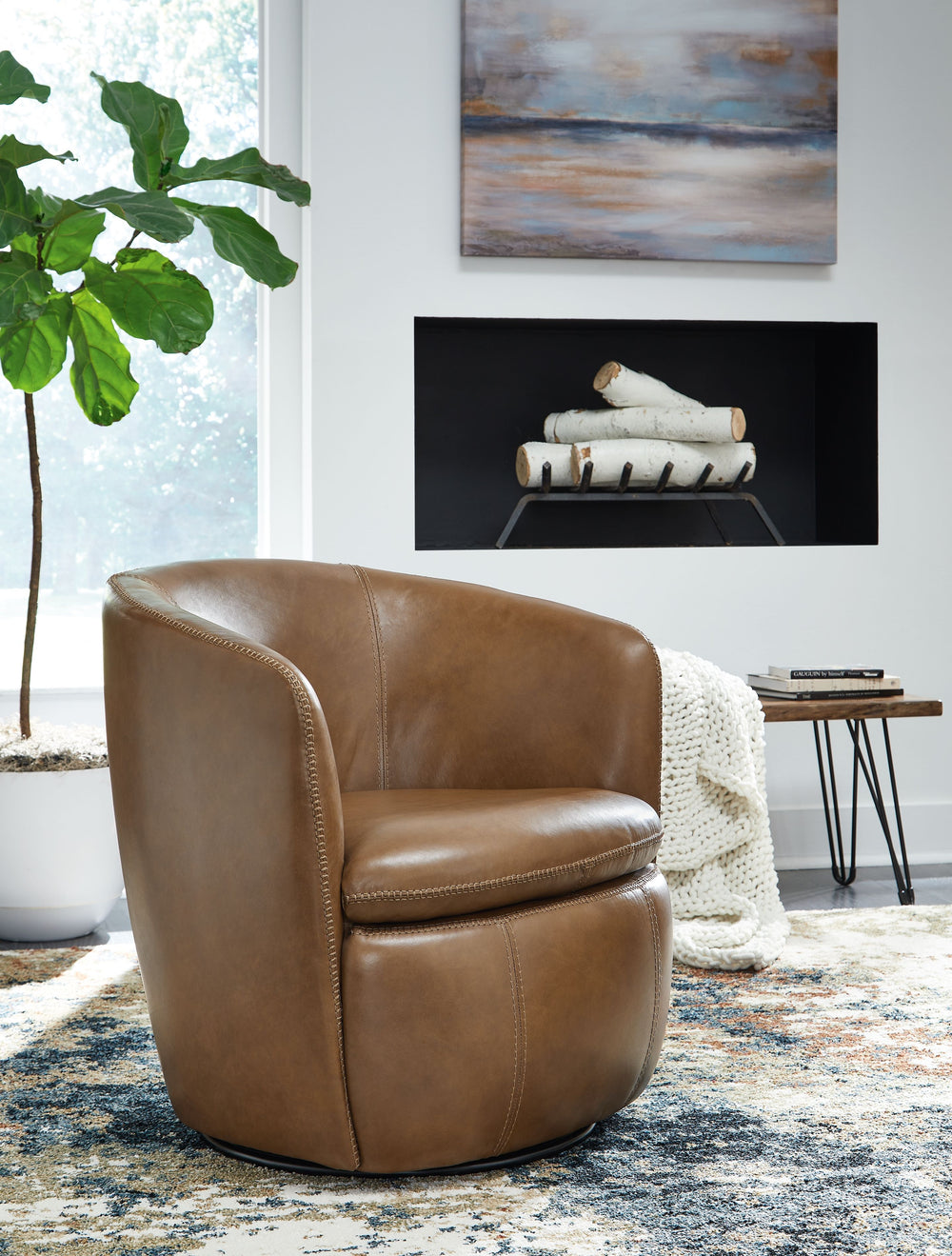Experience the perfect blend of well-appointed comfort and stylish design with this swivel accent chair. Its supple leather and barrel back invite you to settle in and relax, while the sleek 360-degree swivel base keeps you engaged with conversations. Des