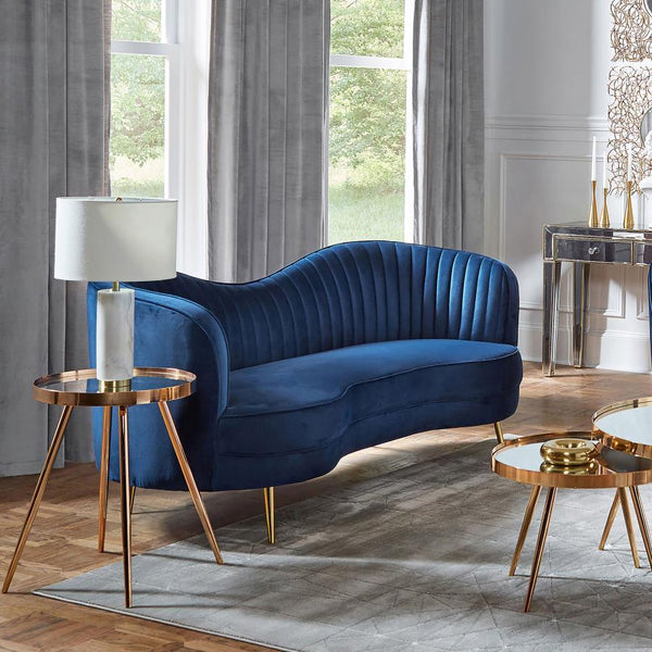  this Art Deco-inspired loveseat features a bright blue velvet upholstery set off with steel tapered legs. Contrasting the deep blue hue is a polished gold finish on each leg. Along with a channel tufted interior cush