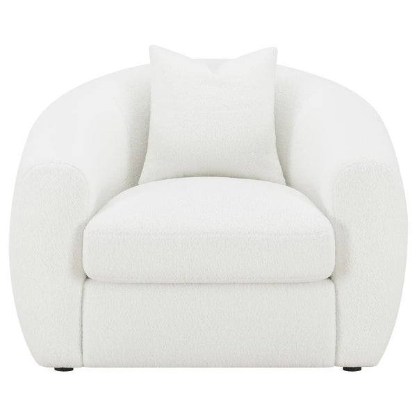  upholstered in a white teddy boucle fabric across its elegantly curved silhouette and sloped armrests. A single accent pillow in a matching boucle rests against the ben