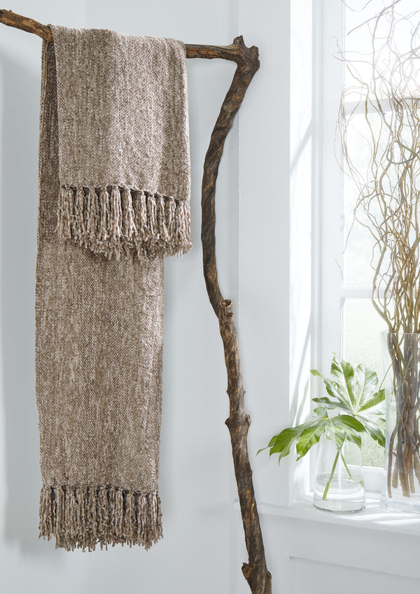  this taupe throw blanket also makes a stylish statement. Whether draped over the arm of a sofa or folded at the foot of a bed