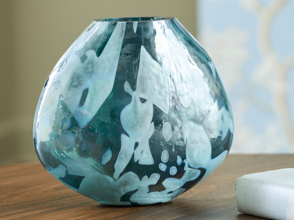 Display florals in captivating contemporary style with this vase. Iridescent details and shades of teal marry to make an artful interpretation of color. Whether it-'s showing off seasonal blooms or standing alone, this piece is a graceful addition to your