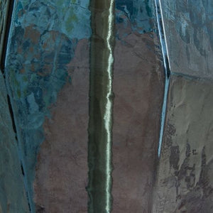  this striking table lamp wows with understated elegance. Its faceted blue glass base adds rich texture and a warm glow to a bedroom or living area