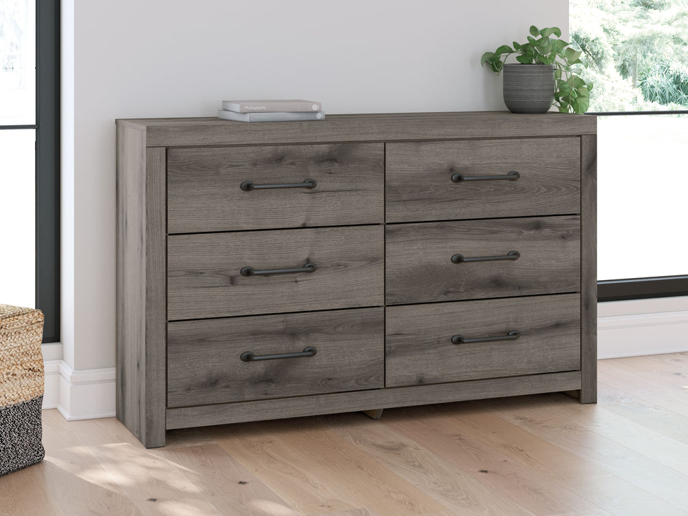 Combining a casual aesthetic with functional flair, this dresser suits styles from rustic to industrial. Its smooth-gliding drawers store everyday essentials with ease, from clothes to bed linens. Elongated drawer pulls in a dark hue polish off the look, 