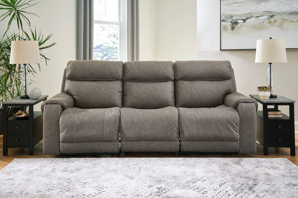 Destination: chic comfort. This power reclining sofa launches your living room into superior form with stellar attention to detail. Exemplifying attainable luxury, its handsome hue has an air of sophistication youâ€™ll long to lounge in. And when youâ€™re