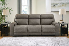 Destination: chic comfort. This power reclining sofa launches your living room into superior form with stellar attention to detail. Exemplifying attainable luxury, its handsome hue has an air of sophistication youâ€™ll long to lounge in. And when youâ€™re