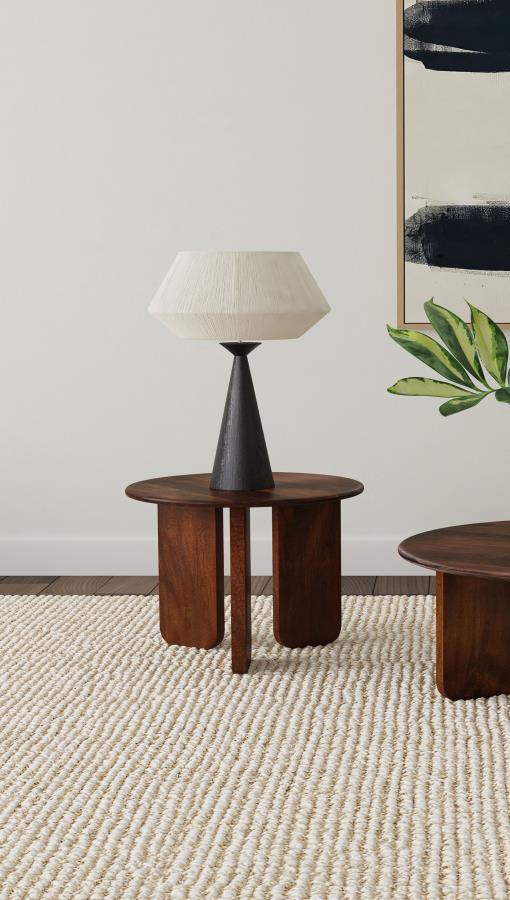 Instill an organic sense of artistry in your living space with this beautifully crafted end table. Made from solid mango wood, it features a deep brown finish that highlights the natural wood grain for added character. The round tabletop provides a stylis