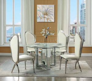 Create a sophisticated modern dining room with the Ningbo round mirrored base dining table. The sleek tempered glass tabletop delivers a stunning complement to the glamorous mirrored geometric base that is accentuated with inlaid crystals. Place by a wind