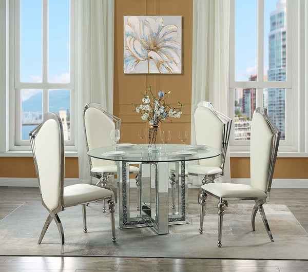 Create a sophisticated modern dining room with the Ningbo round mirrored base dining table. The sleek tempered glass tabletop delivers a stunning complement to the glamorous mirrored geometric base that is accentuated with inlaid crystals. Place by a wind