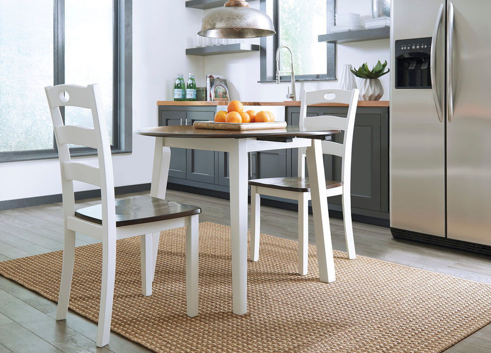 Made with Birch veneers and select hardwood solids in a distinctive two-tone cottage finish. Cream table base and chair frame with medium brown color table tops and chair seats. Updated cottage styling, table has arched aprons and chair has pierced ladder