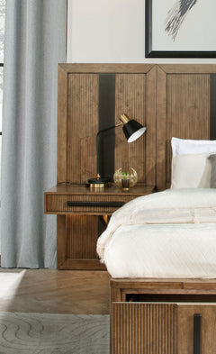 Expand your headboard with the wall panel design of a modern wooden nightstand. It blends seamlessly, perfectly complementing the matching headboard (not included) with vertical fluting and a dark center stripe. The wall panel is adorned with one slim dra
