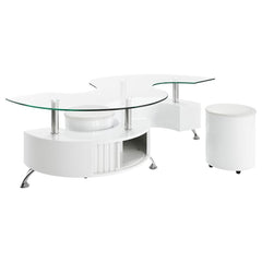 This coffee table features a serpentine shape with a clear tempered glass top and a durable engineered wood base. It includes two stools with padded seats, upholstered in faux leather for added comfort. A sliding door on both sides provides convenient sto